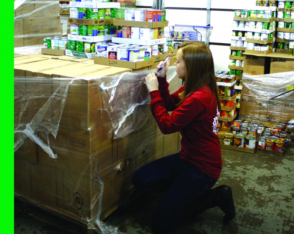 Kristen Allen/The NewsRachelle Peck, junior of Salem, Ky.,, helps stock shelves at Needline. The non-profit organization is one of many involved with Get Connected.