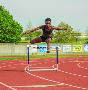 Junior sprinter Sharda Bettis leaps over a hurdle during practice. Kate Russell || The News