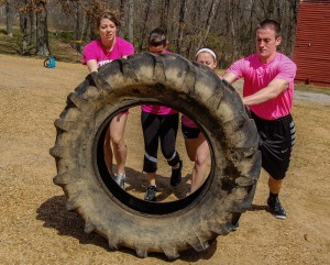 Participants of the Manueuver Murray event work together to overcome many obstcles such as tire flipping in their race for the finish line on Saturday. || Emily C