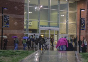 Fans take shelter inside from the pouring rain at the CFSB Center as they wait to be let into the Bob Dylan concert Saturday night. || Lori Allen