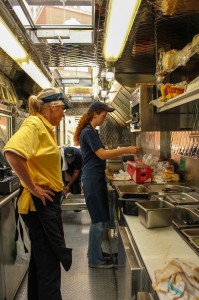 Workers prepare food inside of the truck for students, staff and faculty.   Photo by Kate Russell / The News