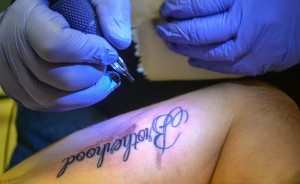 Megan Godby//Contributing photographer / Stash perfects Jones' new "Brotherhood" tattoo.