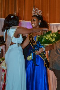 Megan Godby/Contributing photographer  Pearson is congratulated by last year's queen Katie McAllister, senior from Murray.
