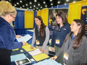 Alex Mahrenholz/The News Murray State FFA seniors Marisa Bedron and Samantha Anderson, and sophomore Hayley Barfield, talk to high school FFA members at the 86th National FFA convention last week. 