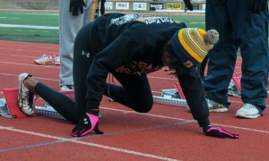Jenny Rohl/The News Sophomore Kiara Austin gets ready to sprint off her blocks during a cold winter practice earlier this year.