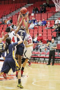 Photo by Lori Allen, illustration by Evan Watson/The News Senior forward Jessica Winfrey attempts a shot in the Racers’ loss Saturday.