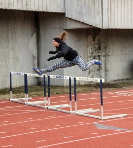 Lori Allen/The News Sophomore Kennedy Berkley jumps over hurdles in a cold morning practice at the Marshall Gage Track.