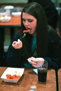 Jenny Rohl/The News Shelby Ruemmler, freshman from Farmsville, Ill., eats wings at Winslow’s Wing Wednesday.