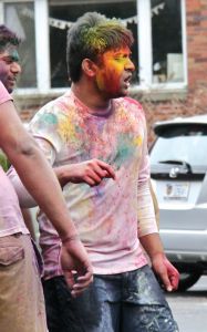 Lori Allen/The News A participant covered in colored powder dances at the Holi Festival Saturday.
