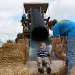 A child looks up at a Fall on the Farm staff worker after shooting down the slide.