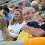 Audrey Heitahoff sleeps on her grandfather Joe Barnett’s shoulder Saturday during the football game against Tennessee State University.