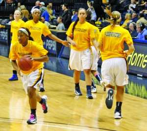 The women’s basketball team drill layups before the game. This win gives the Racers a record of 15-7. || Kristen Allen/ The News