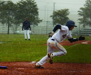 Sophomore Rick Linton runs to first base during Friday's 15-5 loss. Linton recorded one of the 'Breds eight hits of the game.