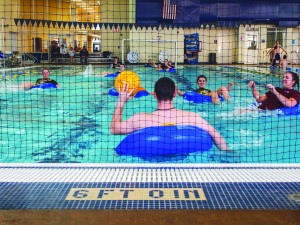 Students participate in an inner tube water polo match. Because the new sport needs the pool at the Susan E. Bauerfiend Wellness Center, the  season lasted four weeks with only one game per week.|| Beamer Barron/The News