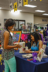 Kelsey Young had her book signed Tuesday by author Galileo Simmons. Simmons had finished a book series her mother had been working on before she passed away. || Kristen Allen