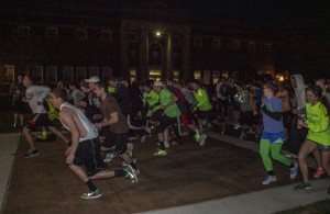 Runners take their places as the begin the 5K Glow Run Friday, April 19. || Taylor McStoots