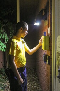 Kate Russell/The News Aaron Burkeen, a sophomore from Murray, checks one of the many call boxes on campus.