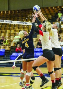 Lori Allen/The News Sophomore setter Sam Bedard goes up for a block against two SEMO players.