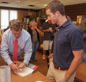 Lori Allen // The News / Drew Brown, a Tenn. resident and Paul supporter, gets his copy of the senator's book signed.