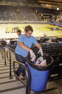 Jenny Rohl/The News Ryan Johnson, senior from Cape Girardeau, Mo., throws away leftover popcorn bogs and old sodas. 