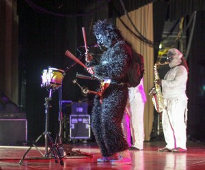 Lori Allen // The News /// Java entertains on stage in a gorilla costume with a strapped on bell instrument which he plays at the same time as a set of drums during the song "Petting Zoo Gorilla."