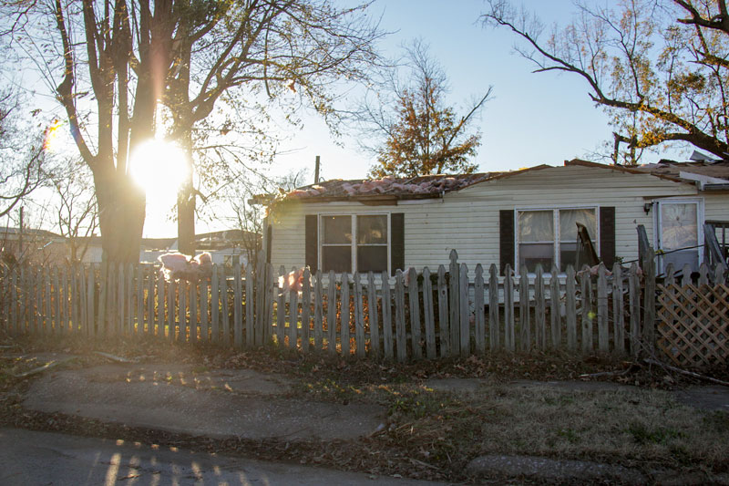 Lori Allen // The News /// The sun sets on Brookport the day after a tornado ripped the roof from this home on Ohio Street.