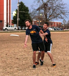 Kate Russell // The News  /// Grad student Ryan Curry, from Springfield, Ill. (left), tosses the disc as freshman Jacob Meadows, from Henderson, Ky., attempts to block.