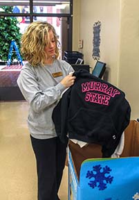 Jenny Rohl / The News University Store employee Tessa Springer sorts donated sweatshirts.