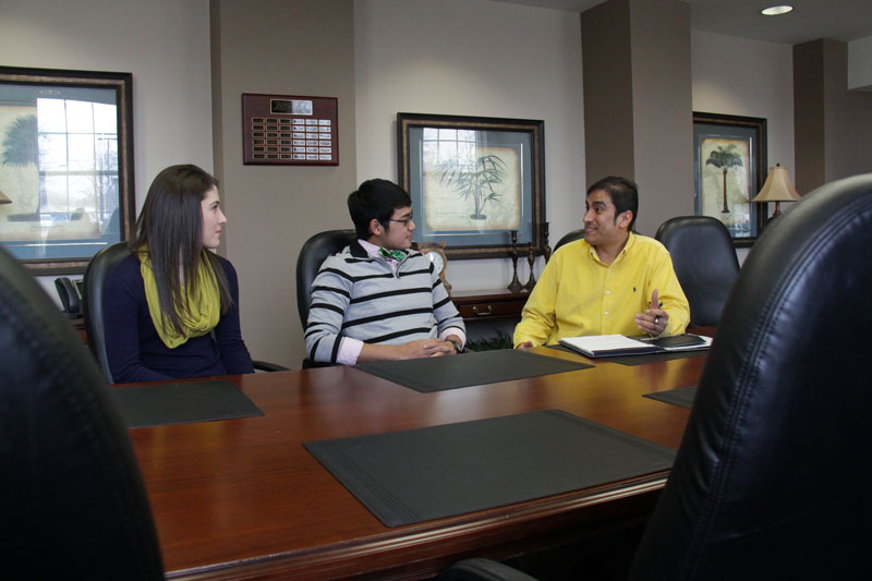 Lori Allen/The News Madison Embry, junior from Morgantown, Ky., and Topaz Prawito, sophomore from Murray, discuss with the new director of Volunteer Income Tax Assistance program, Ray Rodriguez.