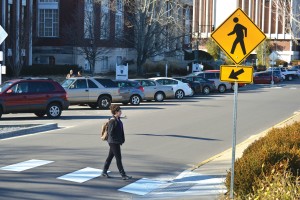 Photo illustration by Kate Russell, photo by Megan Godby/The News After months of bare road, 15th Street now has three crosswalks. The crosswalks were installed on Monday.