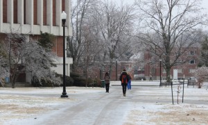 Students trek across ice-covered sidewalks Monday morning.