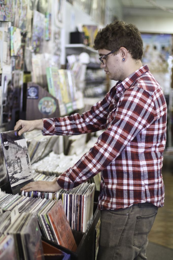 Jenny Rohl/The News Clint Baumgartner, senior from Henderson, Ky., browses through hundreds of vinyl records at Terrapin Station.