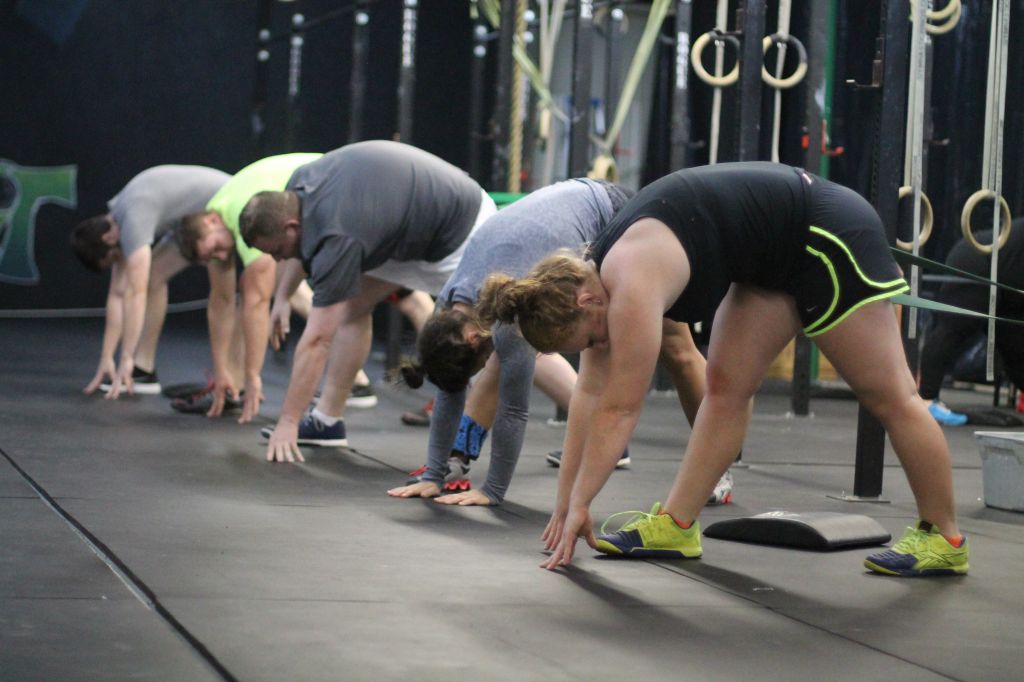 Jenny Rohl/The News Members of CrossFit Murray stretch before beginning the workout of the day, or W.O.D. 