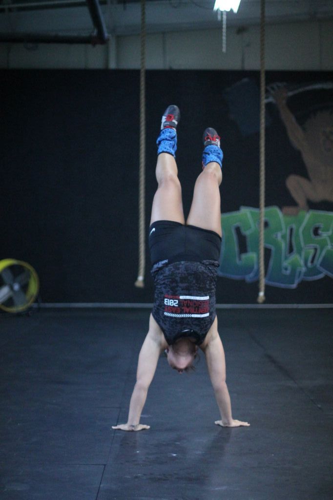 Jenny Rohl/The News Lindsey Smith holds a handstand during a workout.