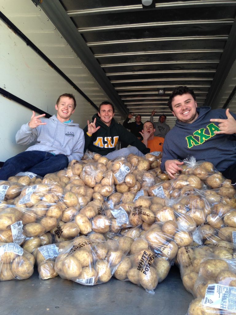 Photos courtesy of Barrett Pazderka Lambda Chi Alphas load potatoes into U-Haul trucks.