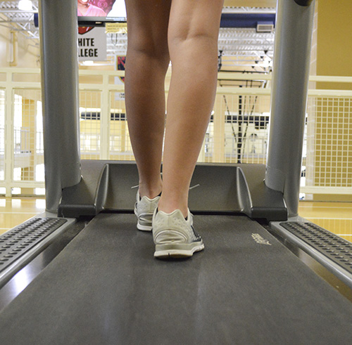 Hannah Fowl/The News A student walks on the treadmill at the Wellness Center.