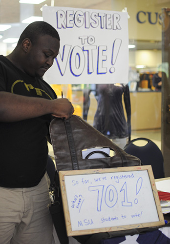 Lori Allen/The News A student stands at a voter registration booth inside the Curris Center. 