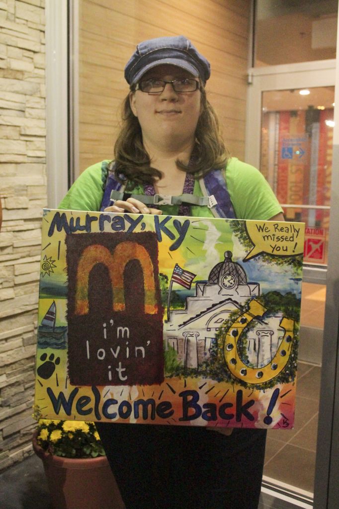 Photos by Jenny Rohl/The News Emily Davis, junior from Hazel, Ky., and her father were the first in line to receive free Big Macs for a year. Davis said she was getting the free Big Macs for her father. She is holding art done by Karl Flood, who hoped McDonald’s would hang up his artwork inside of the restaurant. 