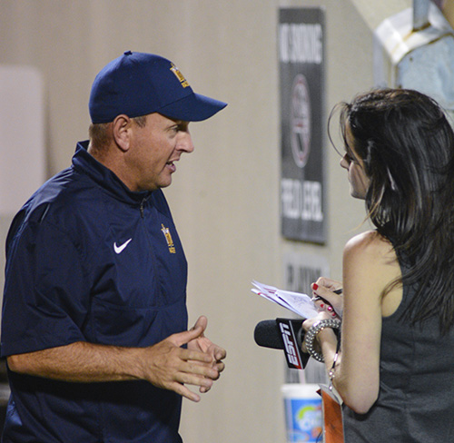 Kory Savage/The News Head Coach Chris Hatcher talks to a reporter at the University of Louisville game Sept. 6.