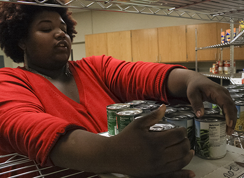 Kalli Bubb/The News Student worker Jamesha Rhodes, graduate student, from Louisville, Ky., stocks the pantry.