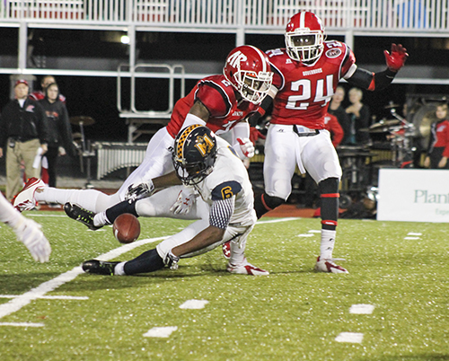 Jenny Rohl/The News Sophomore runningback Marcus Holliday drops a ball as Austin Peay State players pressure him at Governors Stadium Saturday.