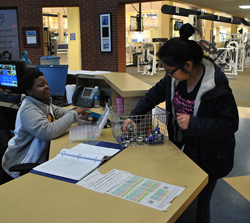 File photo A student uses her Murray State Wellness Center membership to check out a locker lock from Wellness Center employee Serah Waweru.