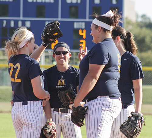 Jenny Rohl/The News The infielders gather to talk during an intrasquad scrimmage earlier this season at Racer Field.