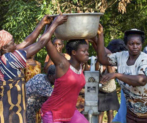Courtesy of Martin Tracy Women and children in Ghana gather around a well to get fresh drinking water. 