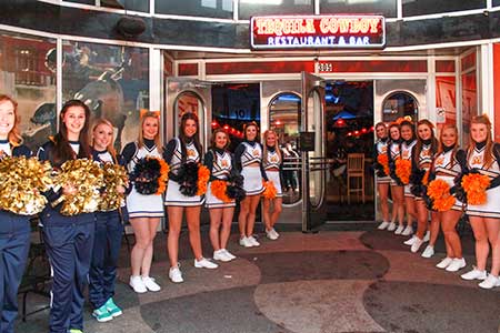 Jenny Rohl/The News Cheerleaders form a tunnel outside Tequila Cowboy March 7 in Nashville, Tenn., to welcome Racer fans to the Alumni Association’s pregame event.