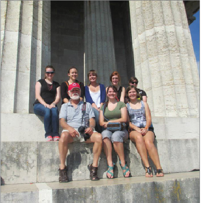 Photo courtesy of Bekah Russell Griffin sits with students from the 2013 Regensburg program at the Walhalla museum, in Donaustauf, Germany.