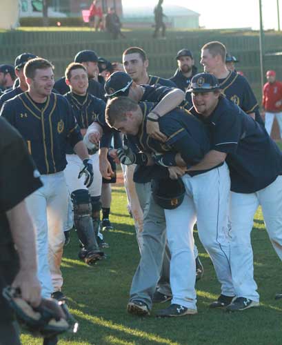 Jenny Rohl/The News The Racers embrace their teammates after winning on April 10.