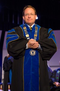 President Bob Davies stands on the stage of Lovett Auditorium Friday during his investiture. Fumi Nakamura/The News