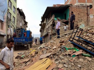 People stand on rubble after the second earthquake to hit Nepal in two weeks. Photo courtesy of Ryan Brooks.
