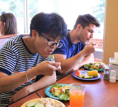 Jenny Rohl/The News Wonsu Kim, graduate student from South Korea, and Deric Hyman, junior from Shelbyville, Kentucky, enjoyed the Harvest Dinner at Winslow Dining Hall Wednesday night. 